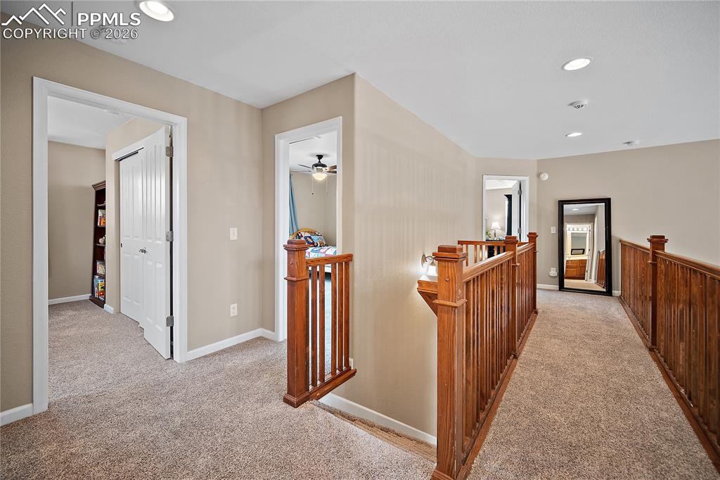 Image 21 of 48: Upstairs with a catwalk that is open to the main level living/family room. 