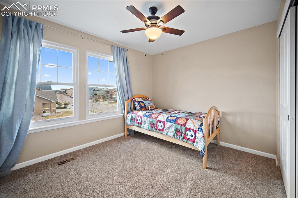 Image 22 of 48: Upstairs bedroom with carpet and large windows for great natural light and 