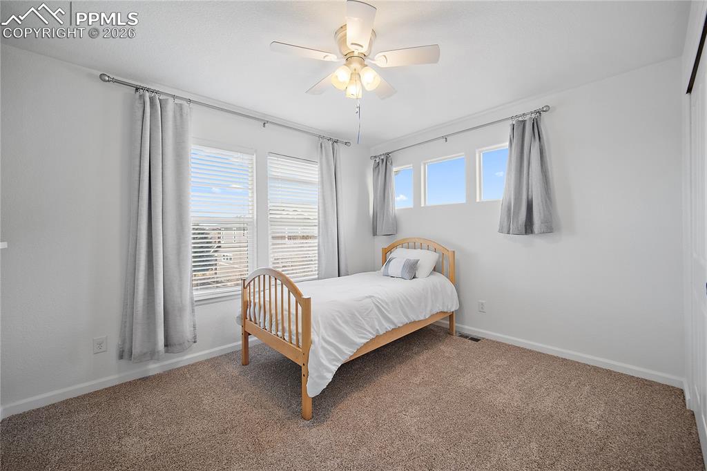 Image 23 of 48: Upstairs bedroom also with carpet and great natural light as well as a ceil