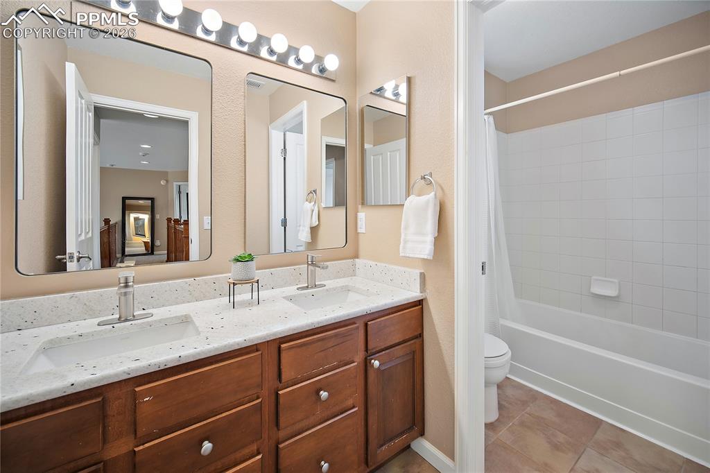 Image 25 of 48: Upstairs full bath with double vanity. 