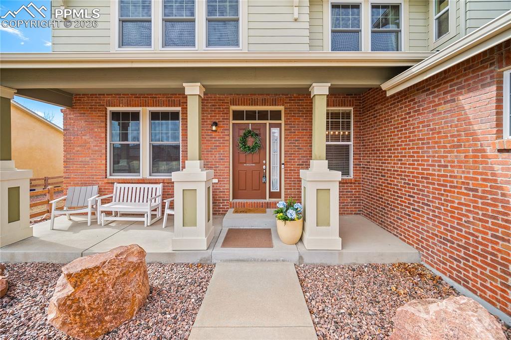 Image 3 of 48: Covered front porch, brick exterior. 