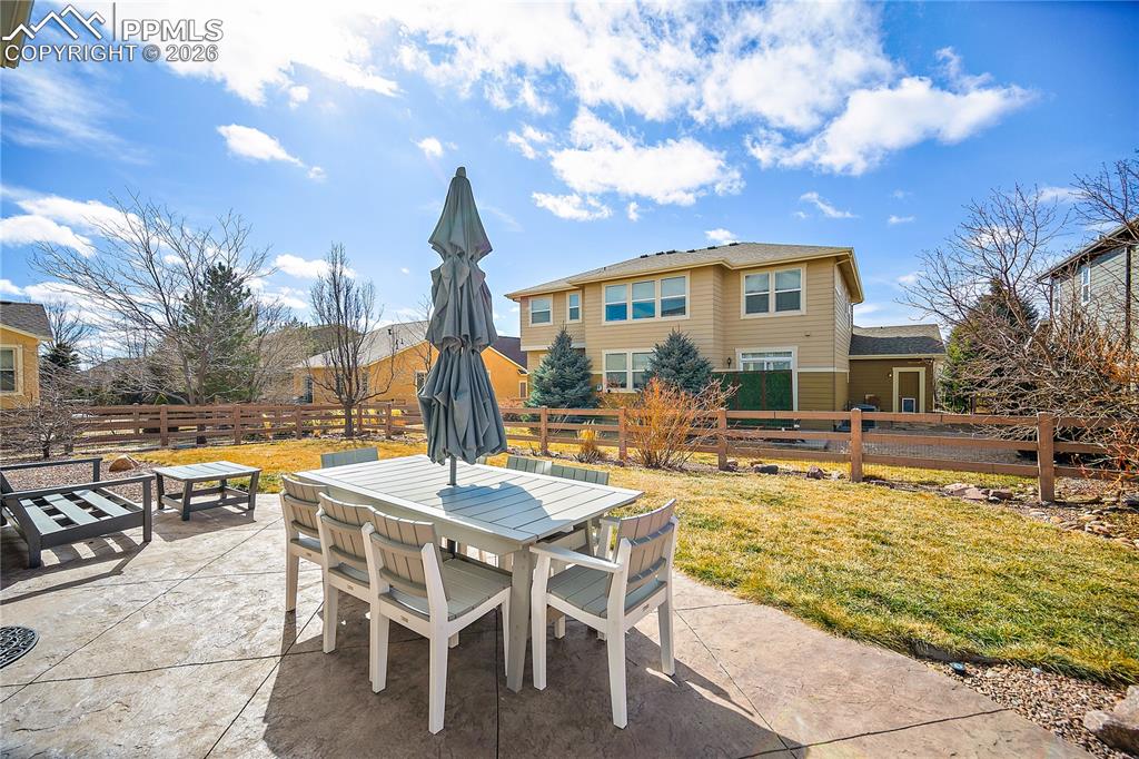 Image 39 of 48: Stamped concrete patio. Fully fenced back yard. Well maintained landscaping