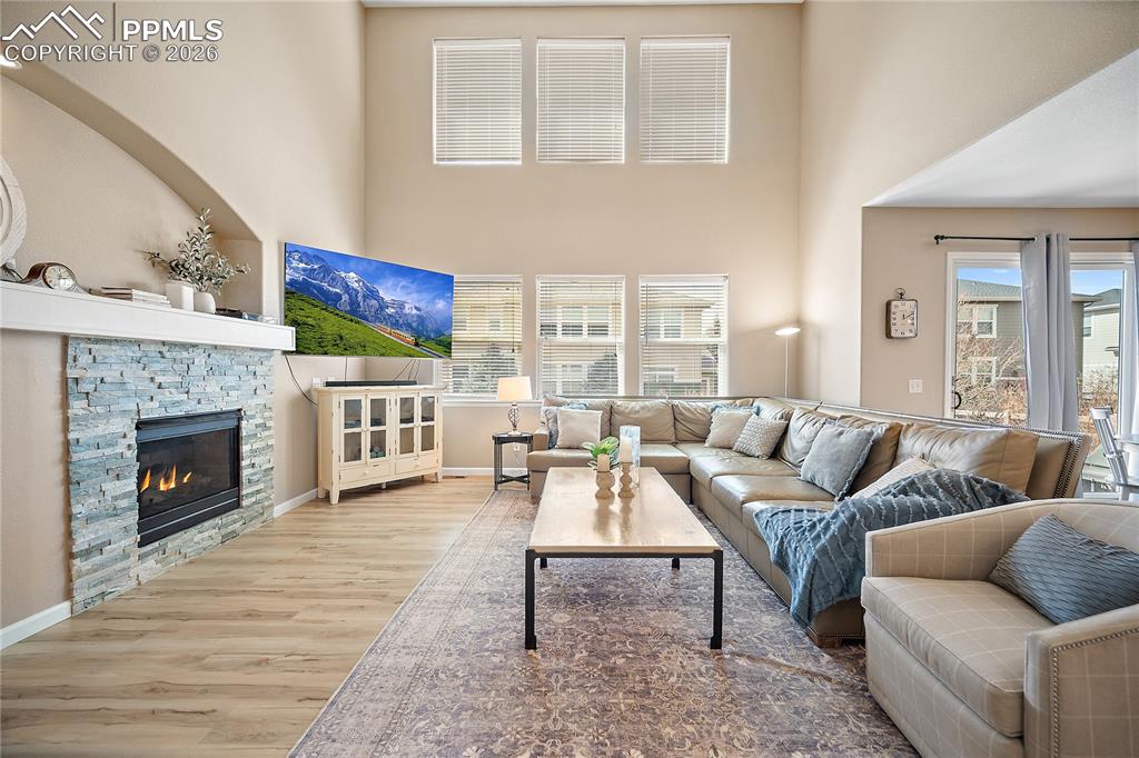 Image 9 of 48: Gas fireplace with stacked stone surround.  