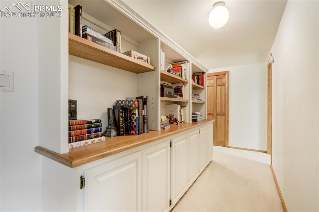 Image 46 of 50: Hallway with built-ins in the basement area