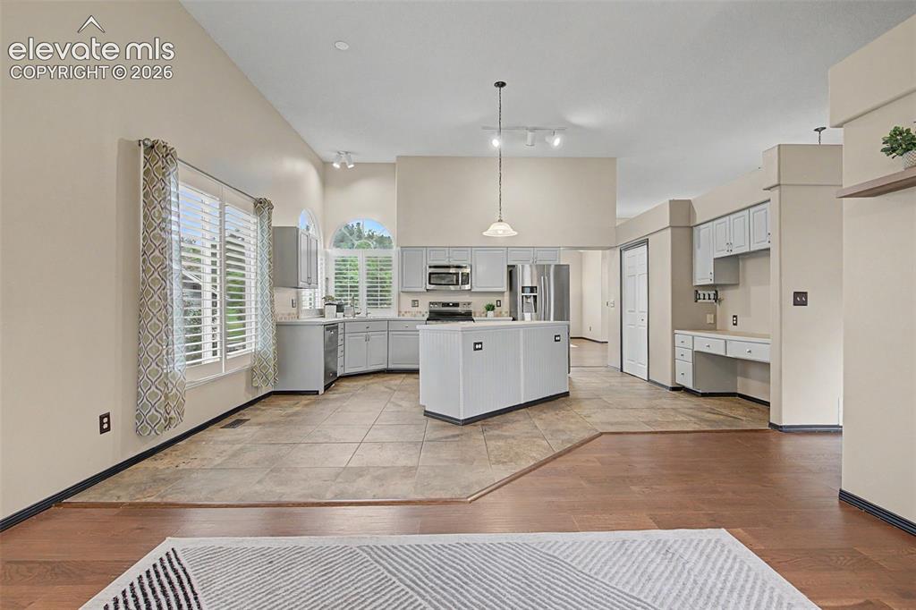 Image 19 of 50: Spacious kitchen area featuring light-toned cabinetry, stainless steel appl