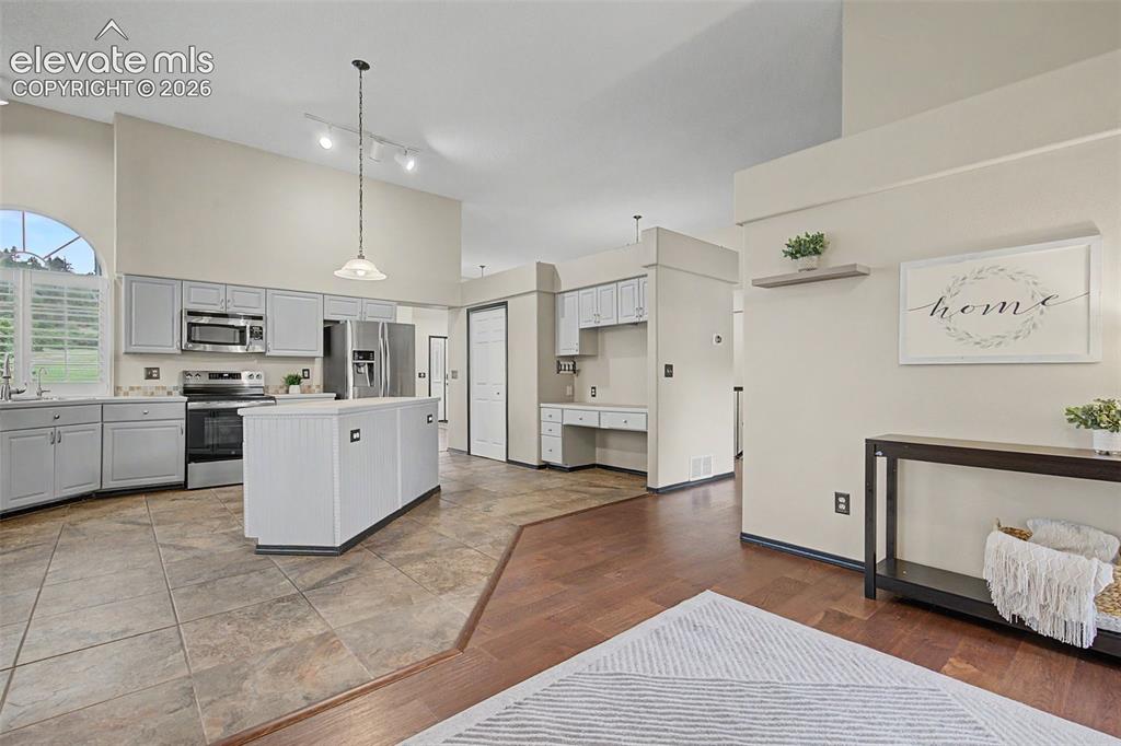Image 20 of 50: Kitchen featuring light gray cabinetry, stainless steel appliances, and a c