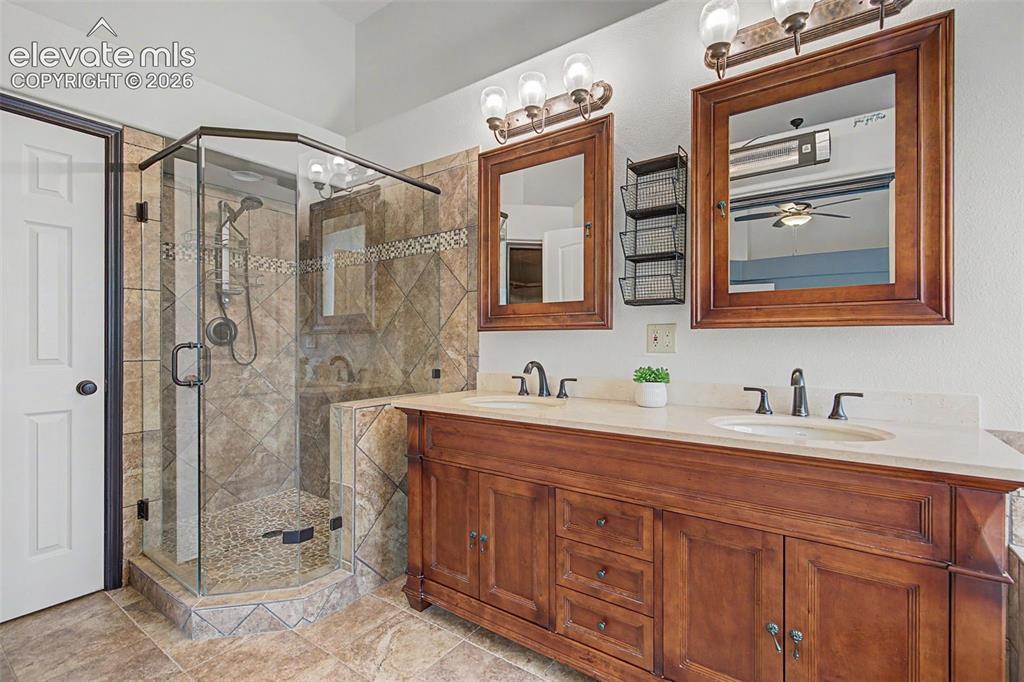Image 30 of 50: Dual vanity with under-mount sinks and brass-finish fixtures