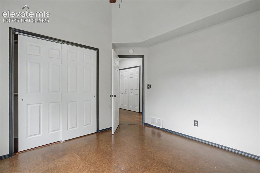 Image 32 of 50: Room featuring light gray walls and wood-finish flooring