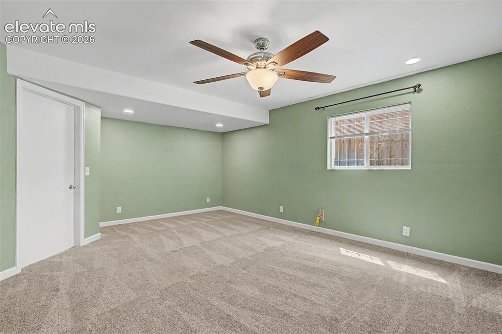 Image 43 of 50: Spacious room featuring neutral carpeting, light green walls, a white ceili