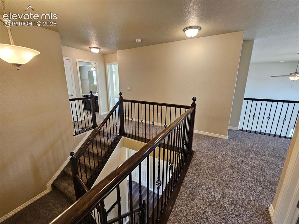 Image 10 of 31: Inviting upper-level landing featuring plush carpet flooring, recessed ligh