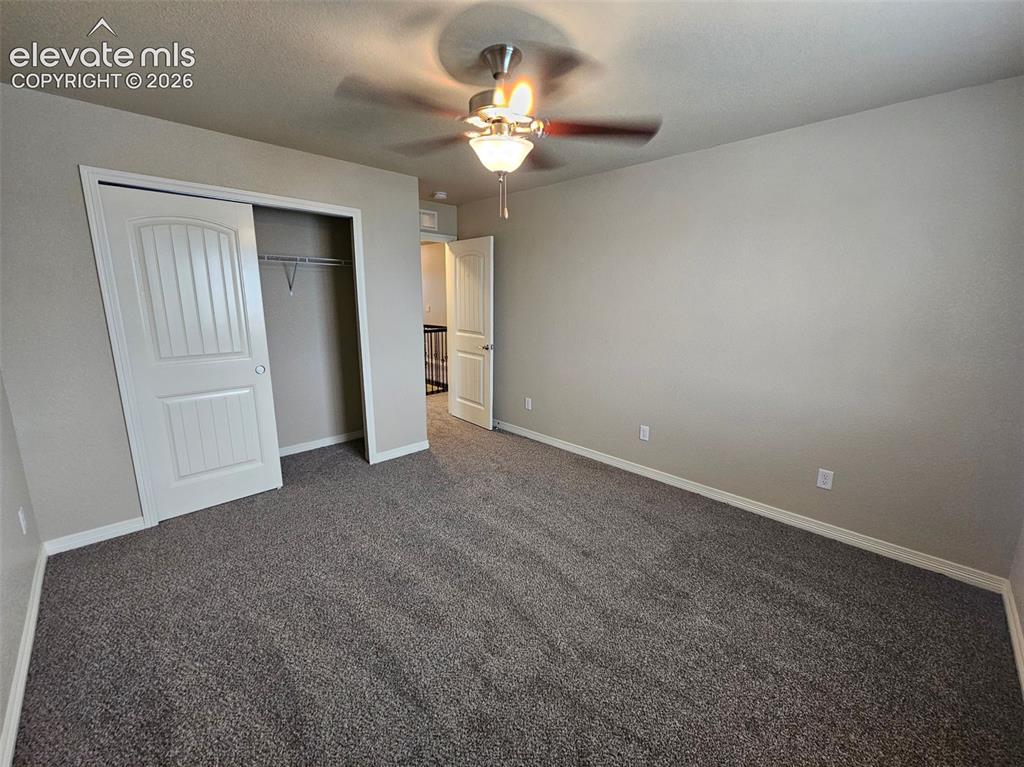 Image 23 of 31: Neutral-toned room featuring a ceiling fan with integrated lighting, textur