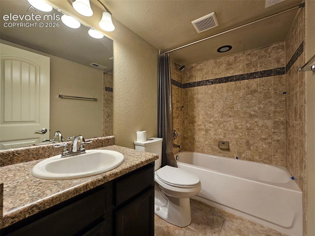 Image 29 of 31: Bathroom featuring a built-in vanity with a countertop, an undermount sink,