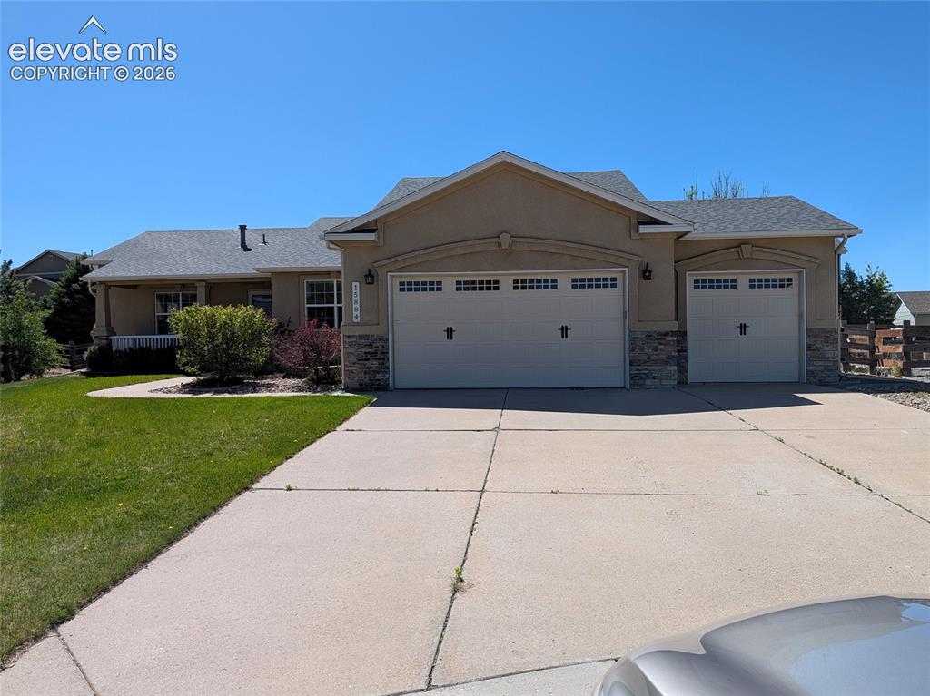 Image 1 of 48: Stucco exterior with stone accents and a covered front porch