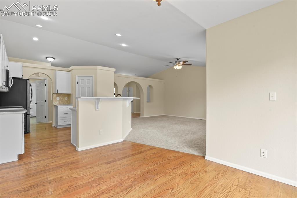 Image 11 of 43: Kitchen and lEat in Dining area featuring wood-finish flooring, a breakfast