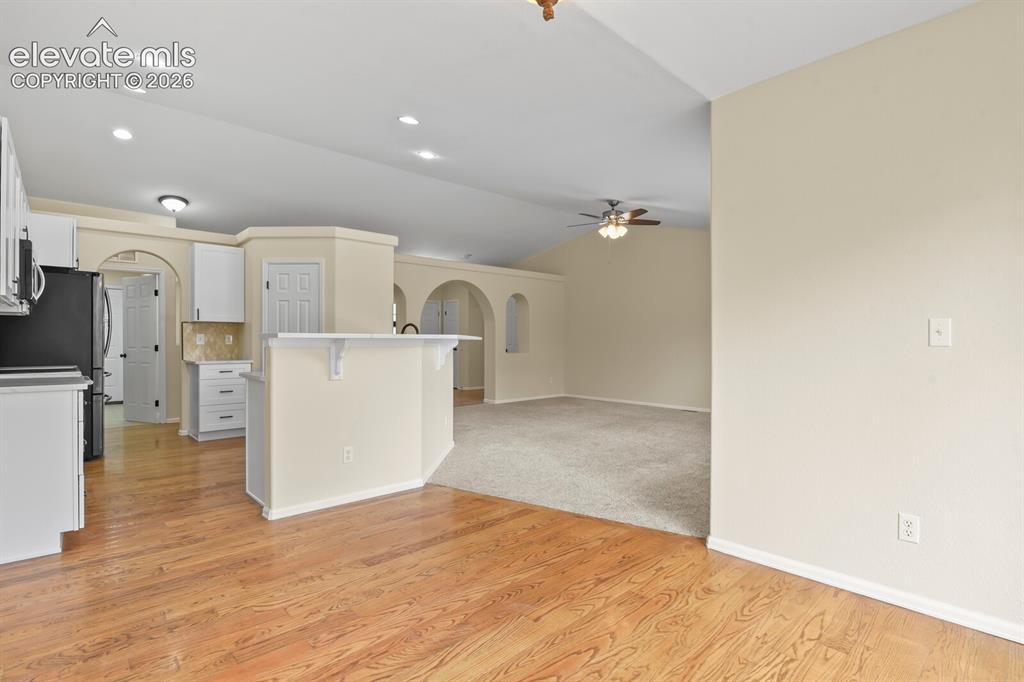 Image 12 of 48: Kitchen and lEat in Dining area featuring wood-finish flooring, a breakfast