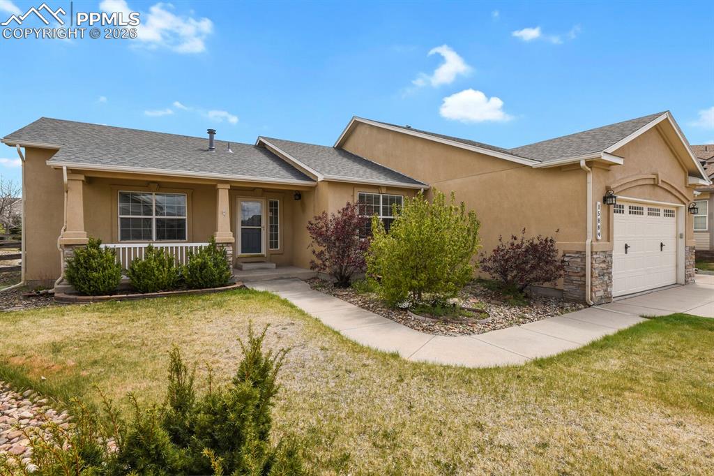 Image 2 of 43: Stucco exterior residence featuring a covered front porch with white railin
