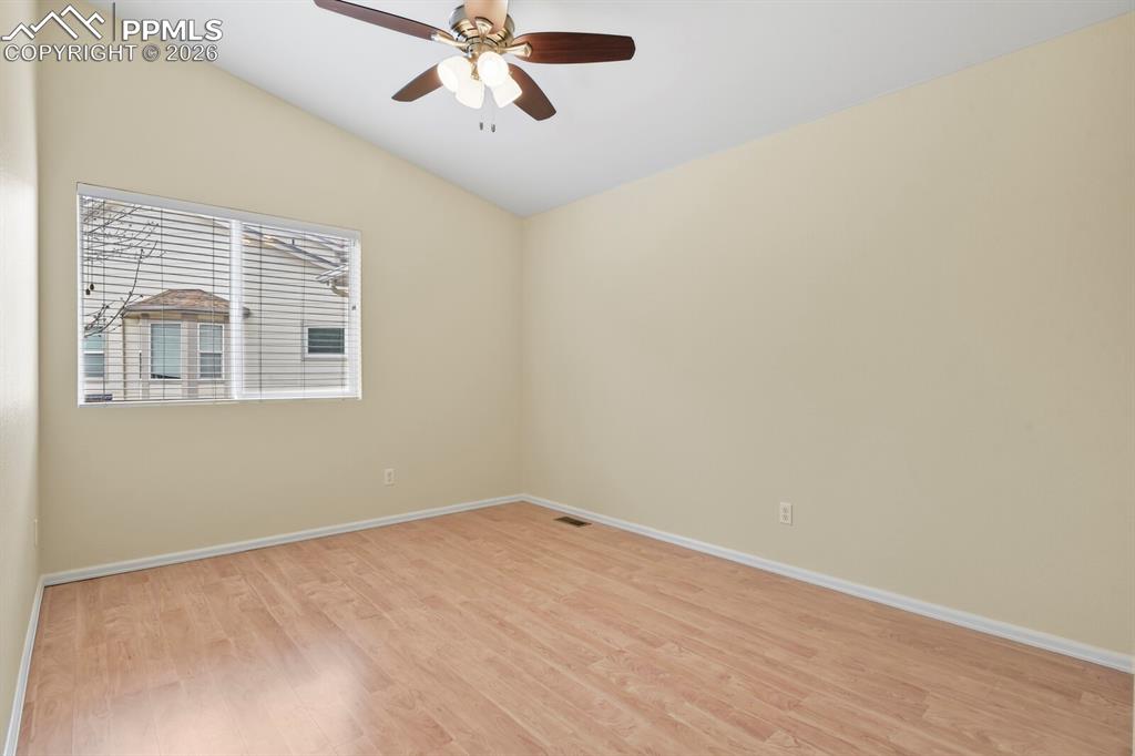 Image 23 of 43: Spacious room featuring vaulted ceilings, wood-finish flooring, a contempor