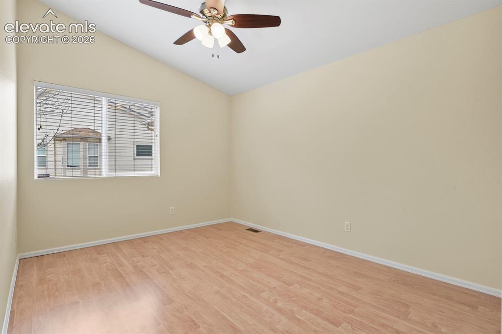 Image 26 of 48: Spacious room featuring vaulted ceilings, wood-finish flooring, a contempor