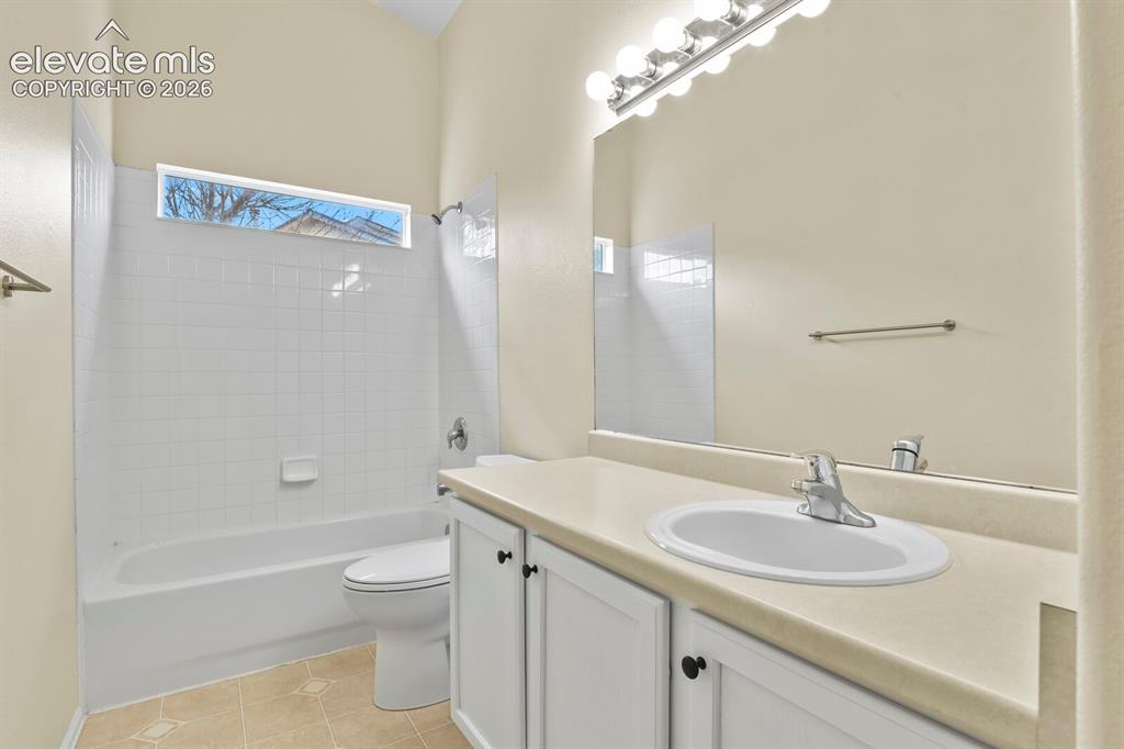 Image 28 of 48: Bathroom featuring a single vanity with a white basin, a full-width mirror,