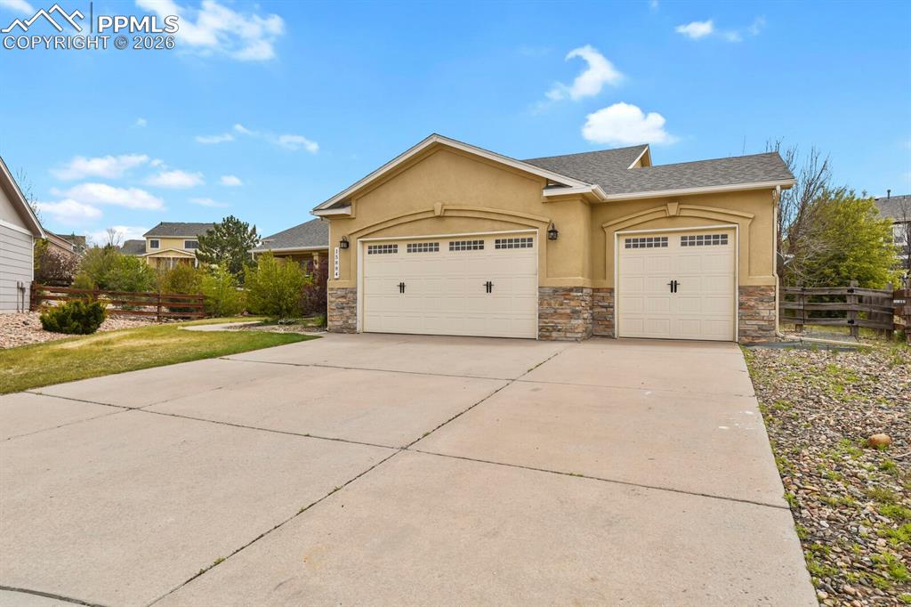 Image 3 of 43: Stucco exterior with stacked stone accents