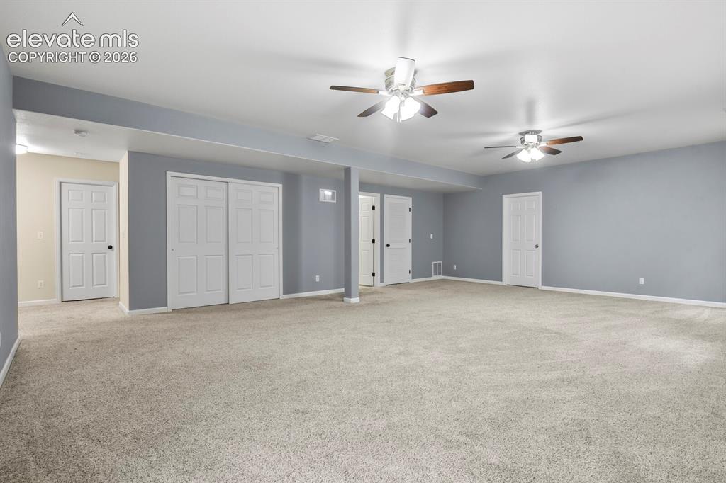 Image 35 of 48: Spacious room featuring light beige carpeting and light grey walls