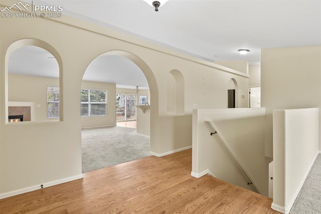Image 5 of 48: Hardwood-finish flooring at the entry, archways, and a multi-level layout,