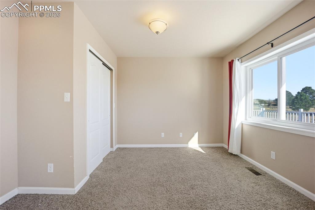 Image 12 of 50: Main level bedroom or office, with a closet and carpet