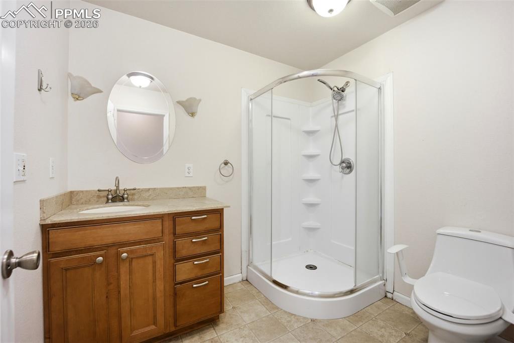 Image 15 of 50: Main level full bathroom with shower stall
