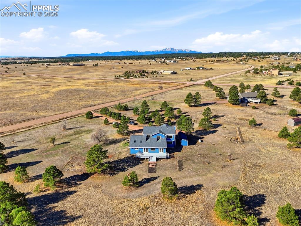 Image 3 of 50: Overview of rural landscape with a mountainous Pikes Peak view