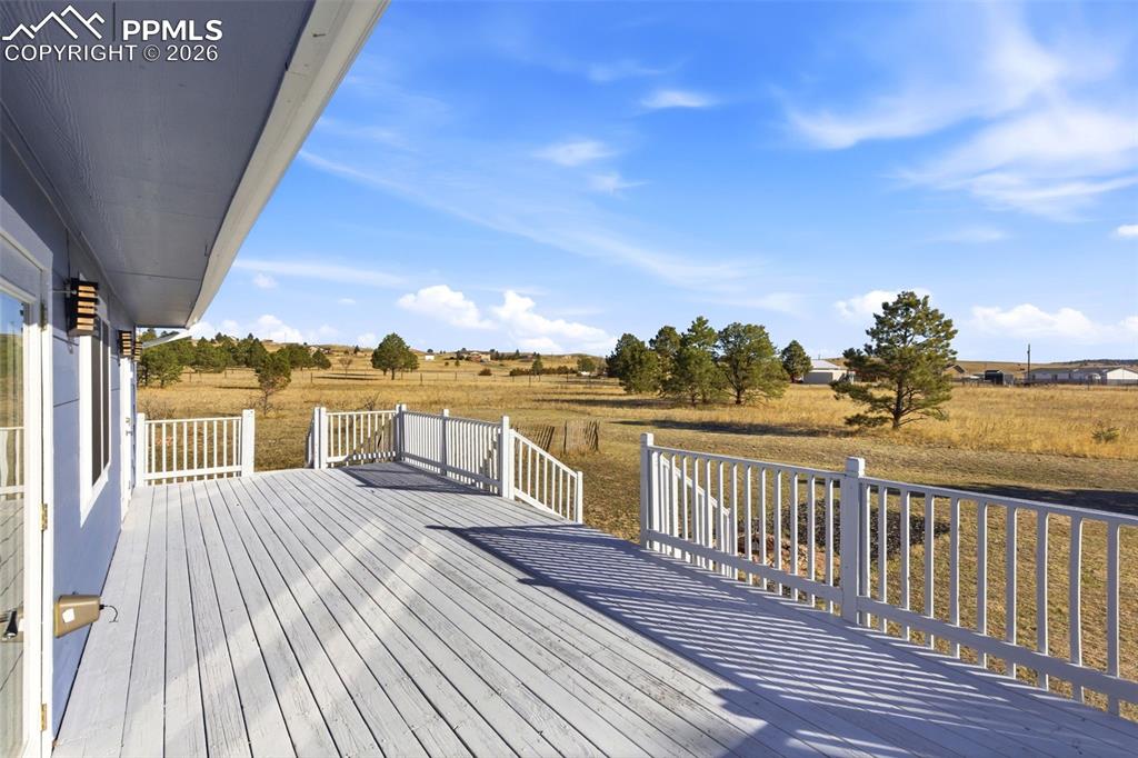 Image 42 of 50: Large wooden deck with a view of rural / pastoral area
