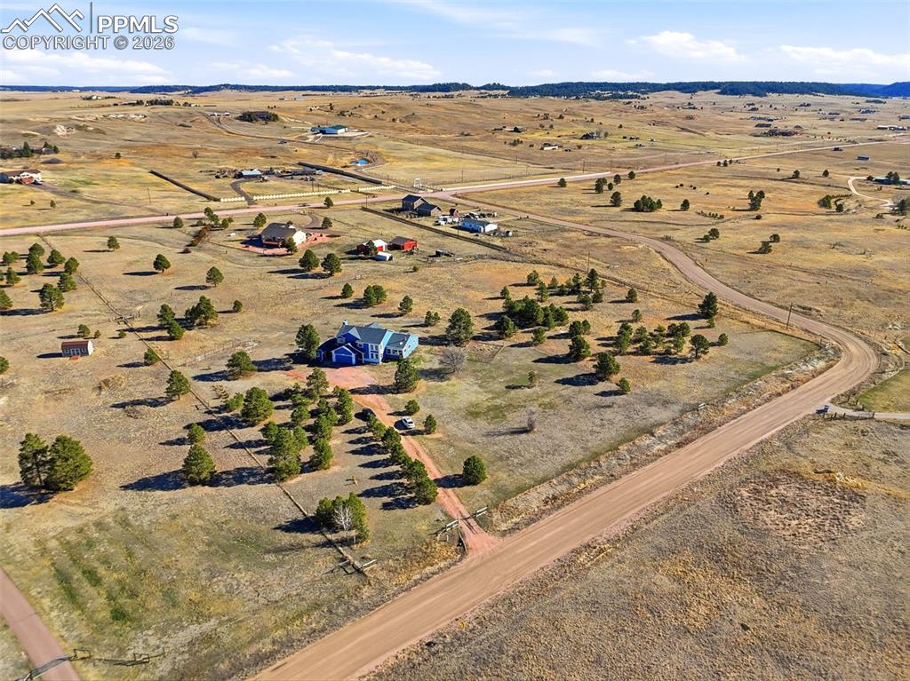 Image 47 of 50: Aerial view of property and surrounding area with rural landscape