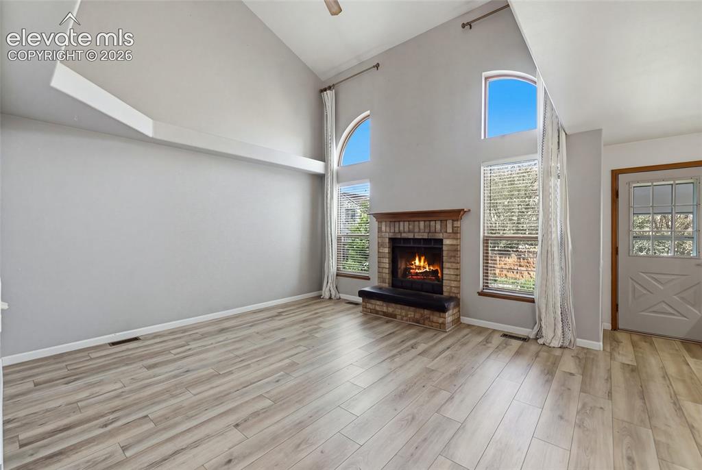Image 15 of 50: Vaulted ceilings with architectural accent beams, wood-finish flooring, bri