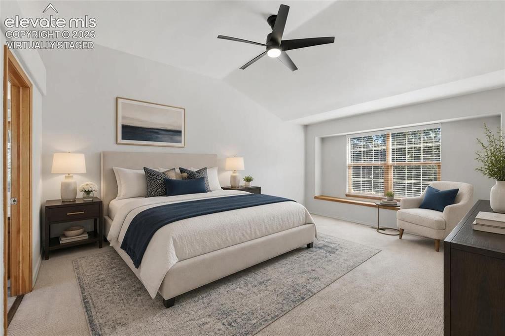 Image 25 of 50: Virtually staged.  Vaulted ceiling with an attached ceiling fan, large wind