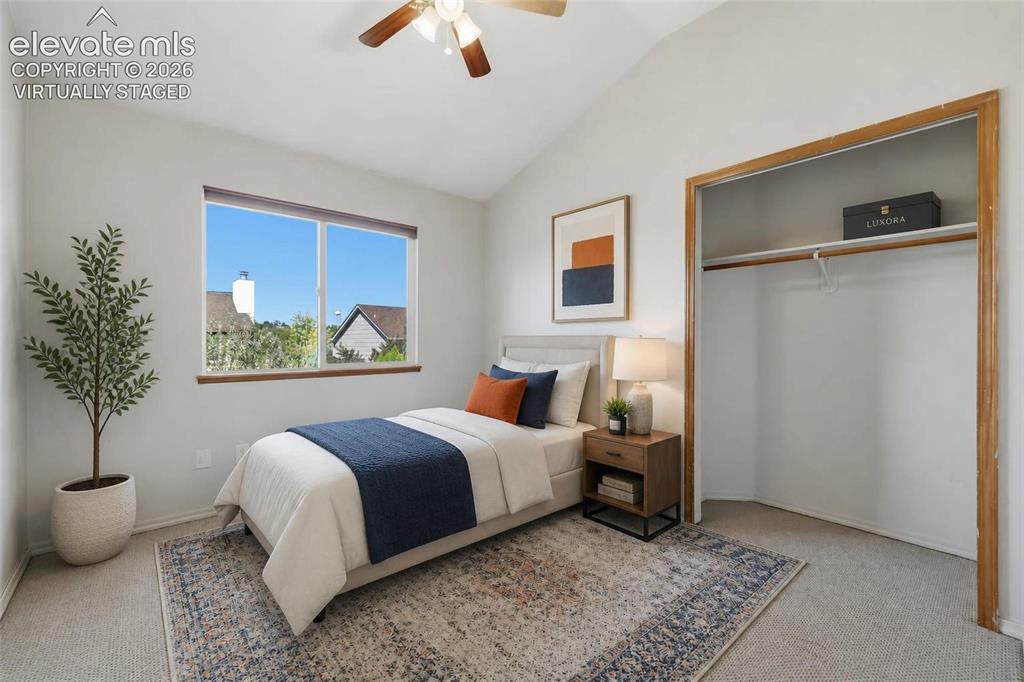 Image 28 of 50: Virtually staged Upper bedroom with Vaulted ceiling with a ceiling fan, dua
