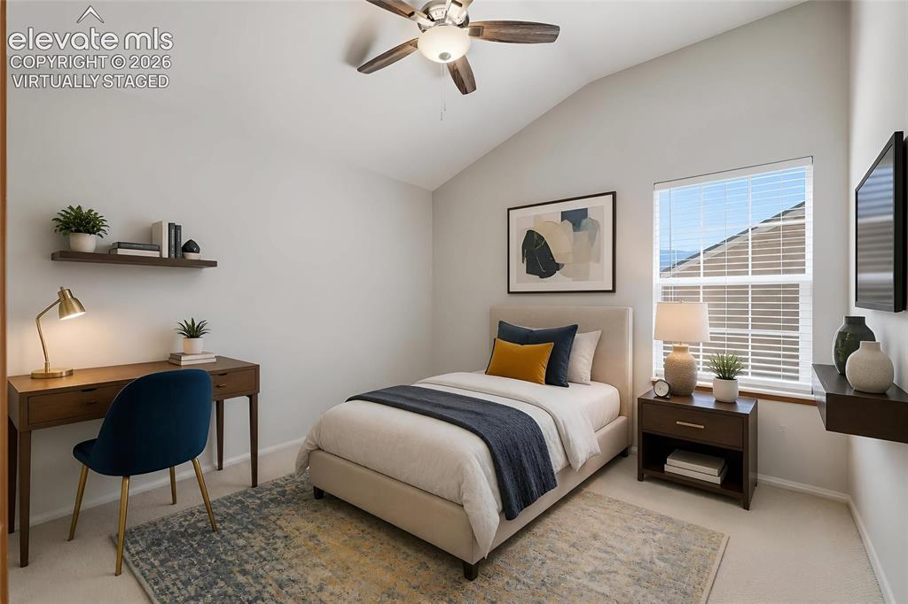 Image 30 of 50: Virtually staged upper bedroom Vaulted ceiling with a ceiling fan, wall-mou
