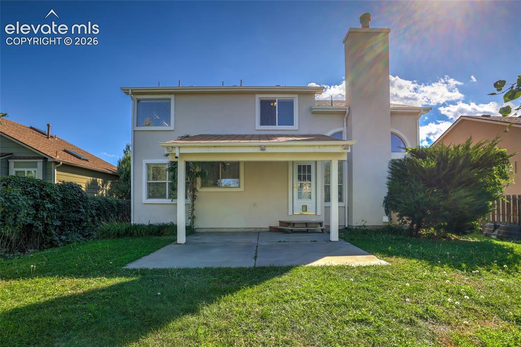 Image 44 of 50: Rear exterior with covered patio, stucco finish, multiple windows, and a pr
