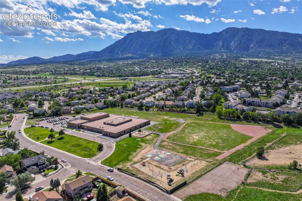 Image 46 of 50: Expansive mountainous backdrop framing a residential area with varied housi
