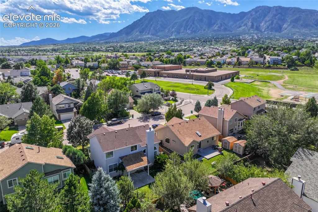 Image 47 of 50: Mountain backdrop, residential neighborhood with established trees, and com