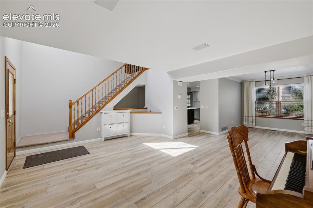 Image 6 of 50: large living room with lvp flooring and plenty of sunlight