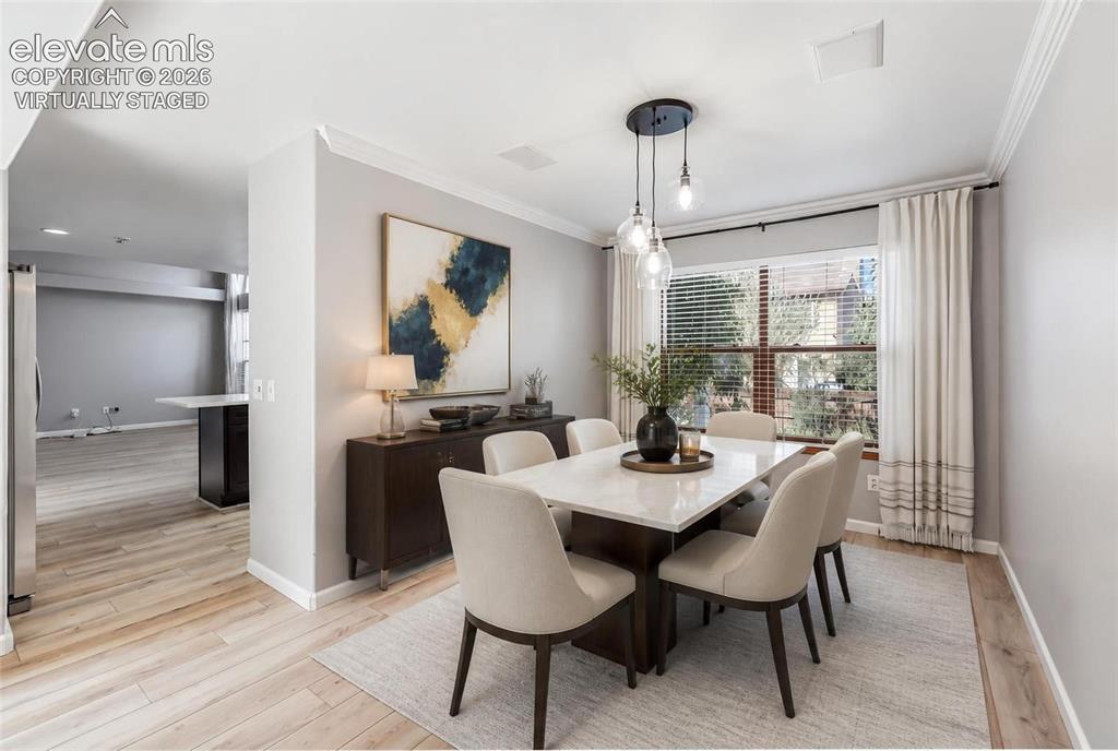 Image 9 of 50: Virtually staged. Dining area featuring wood-finish flooring, a contemporar