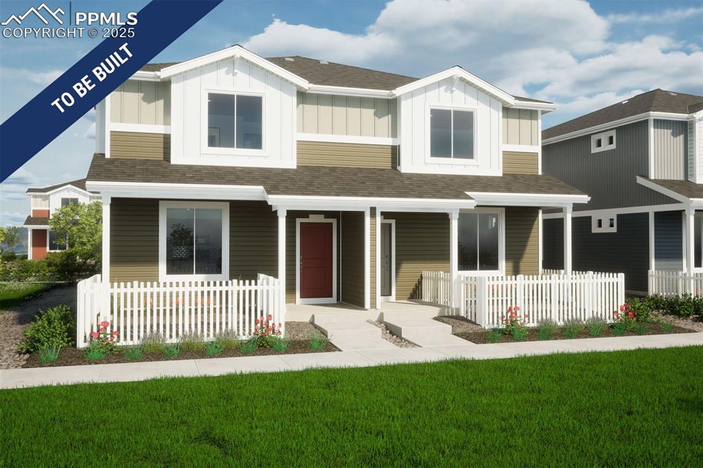 Caption: View of front of house with roof with shingles, a porch, board and batten siding, and a front lawn