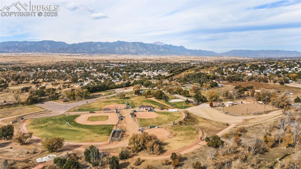 Image 11 of 11: Aerial view of property and surrounding area with a mountain backdrop