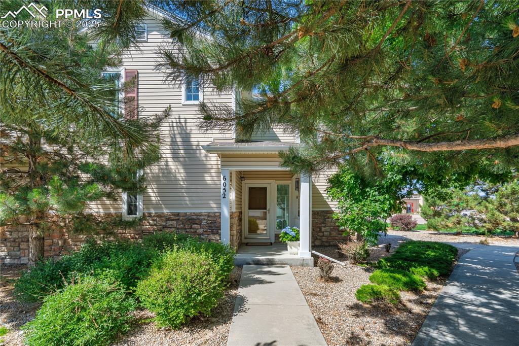 Caption: View of exterior entry with stone siding
