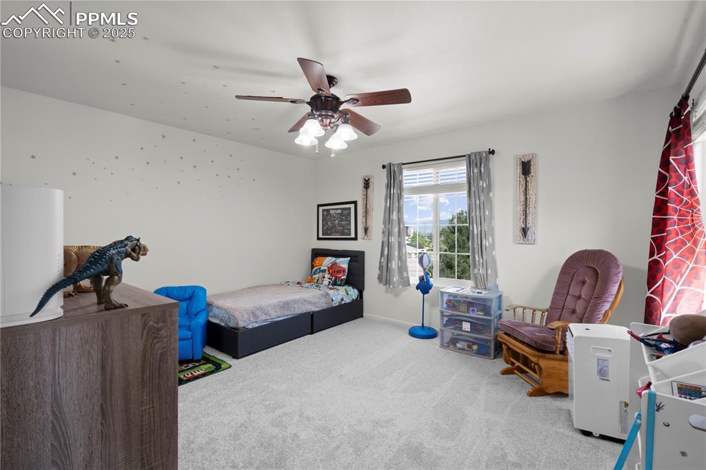 Image 16 of 29: Bedroom with carpet floors and a ceiling fan
