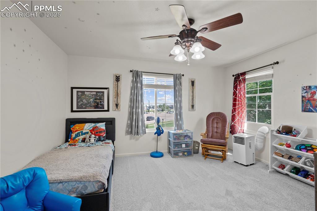 Image 17 of 29: Bedroom with carpet flooring and ceiling fan