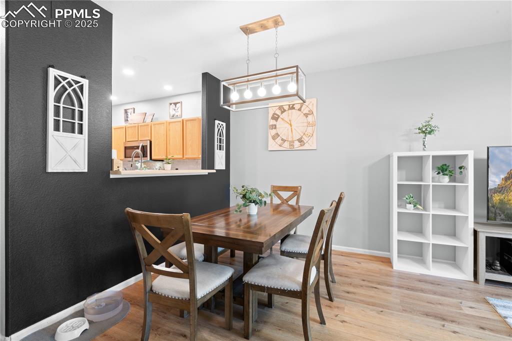 Image 7 of 29: Dining room featuring light wood-style floors and recessed lighting