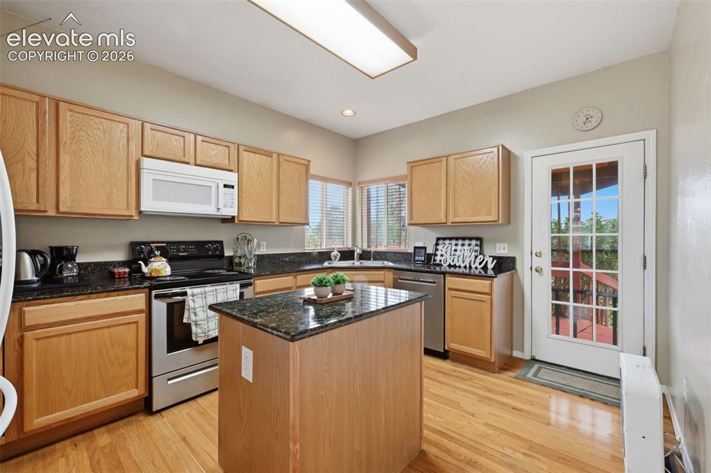 Image 10 of 31: Gorgeous kitchen with walk out to deck and views of Pikes Peak!