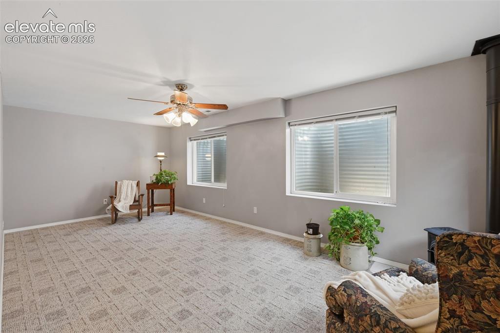 Image 18 of 31: Spacious second family room in the basement with wood burning stove!