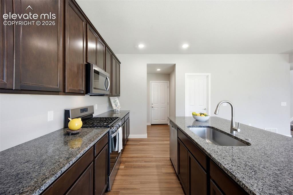 Image 15 of 49: Granite Counters and Large walk in pantry