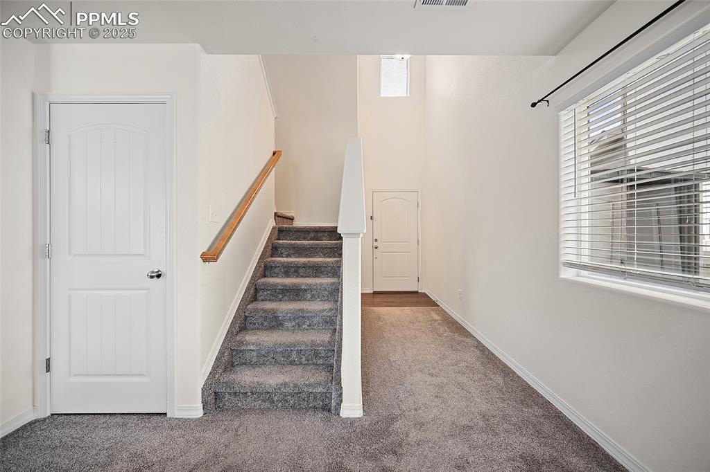 Image 13 of 50: Stairs featuring carpet and baseboards